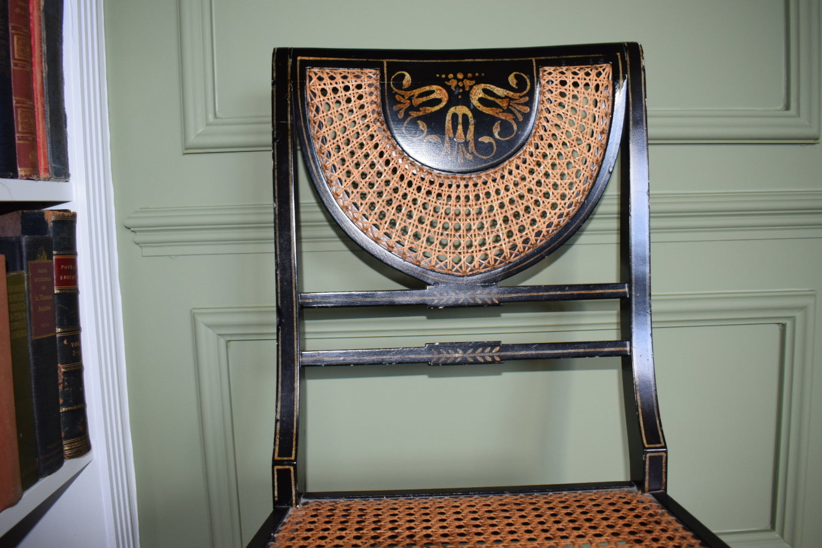 A Regency style black and gilt painted bedroom chair