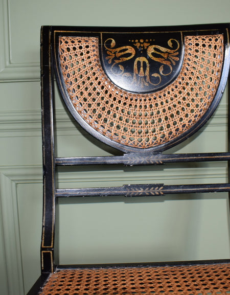 A Regency style black and gilt painted bedroom chair
