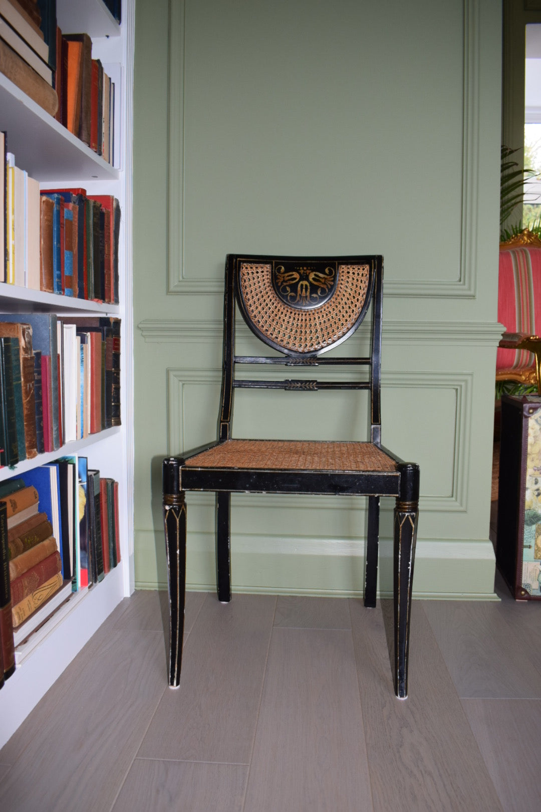 A Regency style black and gilt painted bedroom chair