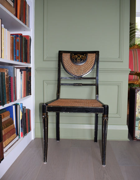 A Regency style black and gilt painted bedroom chair