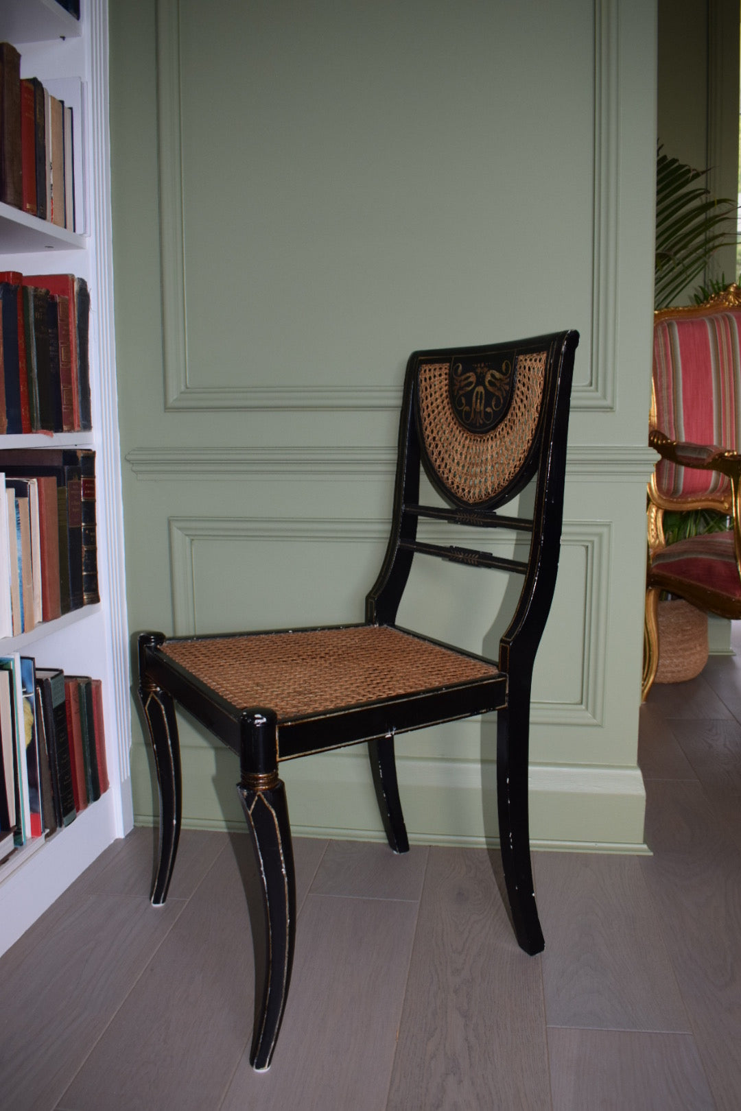 A Regency style black and gilt painted bedroom chair